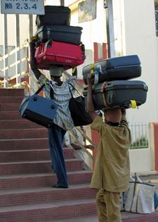 men-carrying-too-much-carryon-luggage