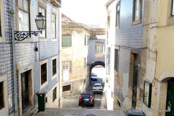 Steep street, arch through Moorish city wall